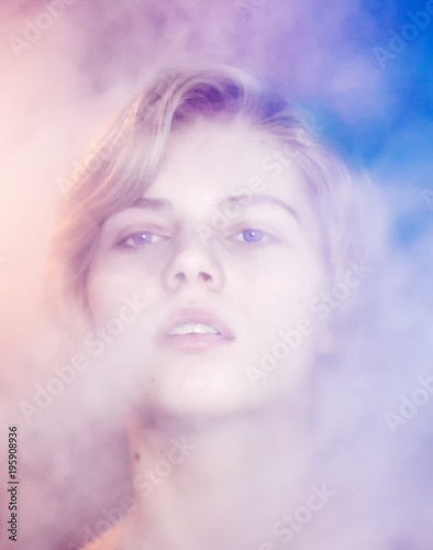 Fototapeta Naklejka Na Ścianę i Meble -  Portrait of a beautiful blonde in the smoke