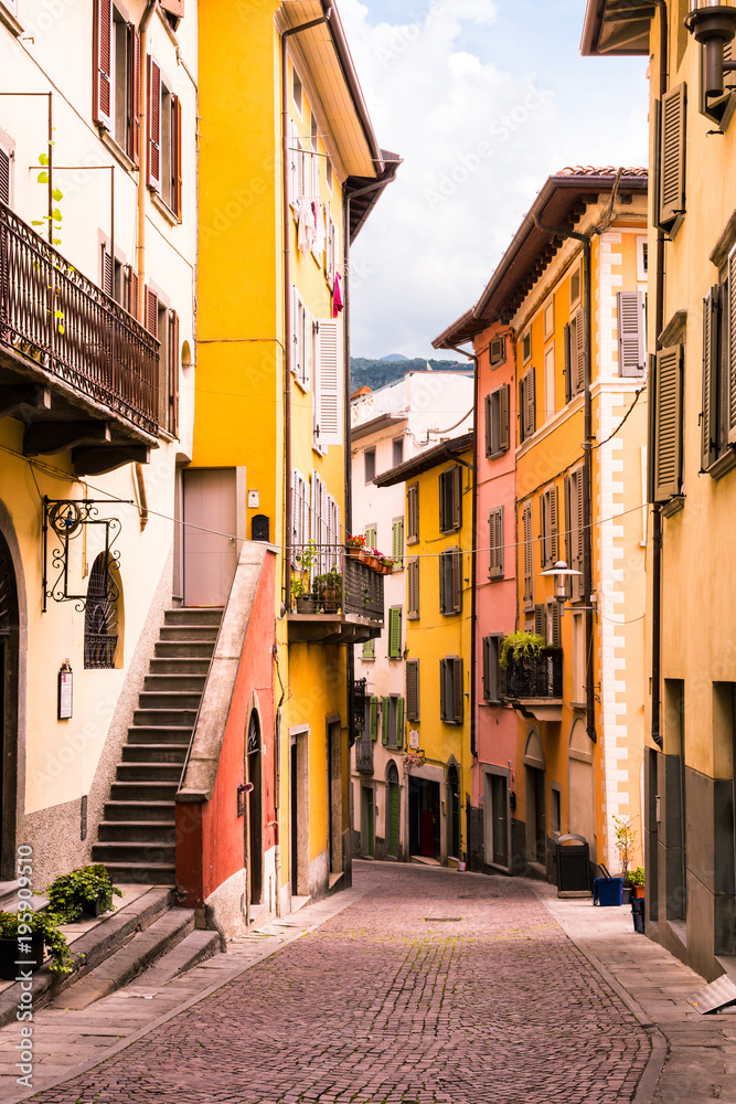 Old scenic street with colorful houses with wooden shutters of the old town. Tourist attraction