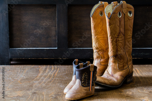Baby boots and adult boots together