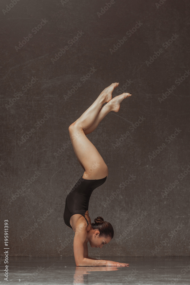 Young yoga woman stretching and training in class Young yoga woman stretching and training in class