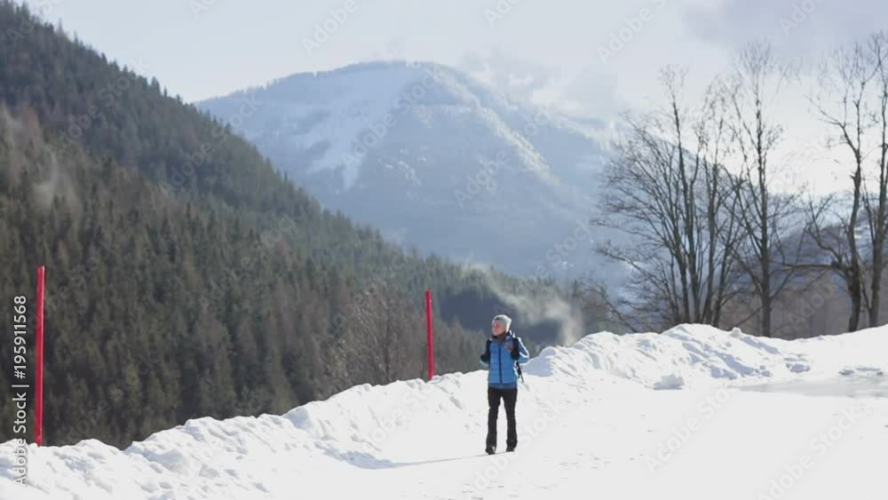 Woman walking in the mountains and looking at beautiful view, Alps, Austria