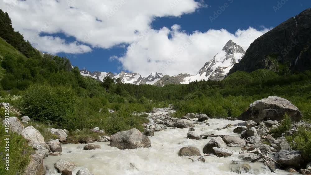 Russia, time lapse. Movement of clouds and water flows in a stormy river in the Caucasus mountains in summer Russia, time lapse. Movement of clouds and water flows in a stormy river in the Caucasus mountains in summer