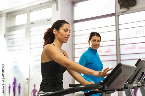 Women working on treadmill.