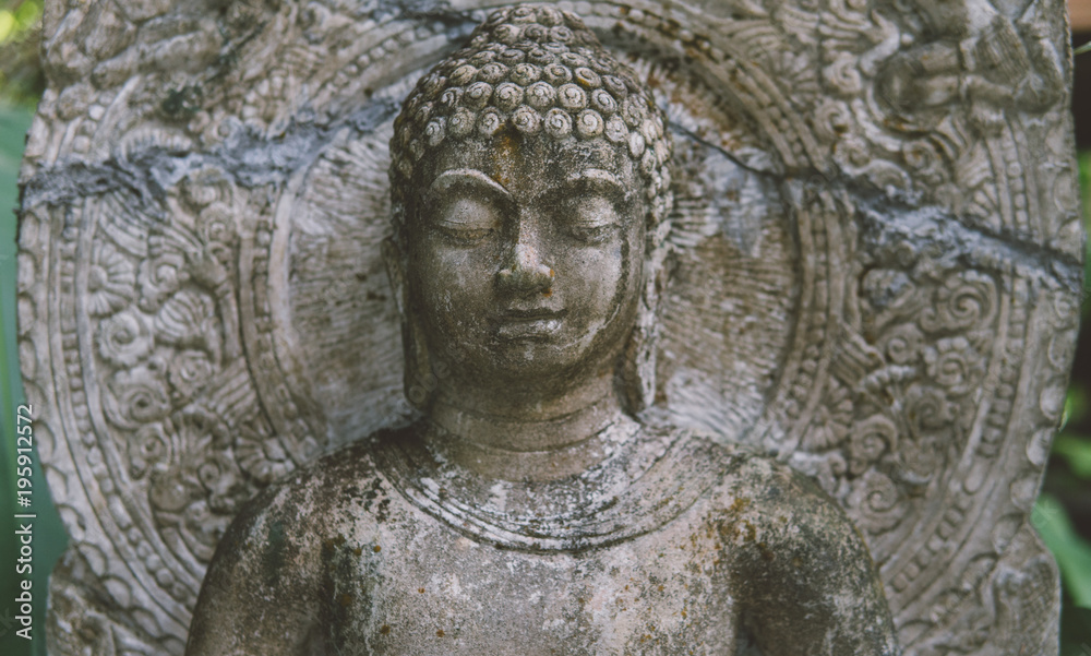 Buddha statue made from the stone closeup. .Buddha as a symbol of