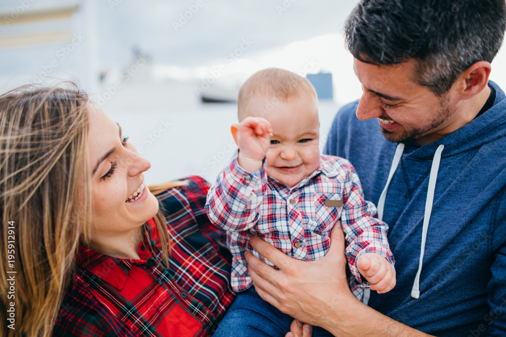 happy family mother and father playing with a baby at home happy family mother and father playing with a baby at home