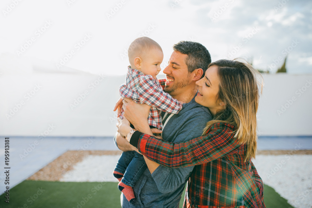 Fototapeta premium happy family mother and father playing with a baby at home