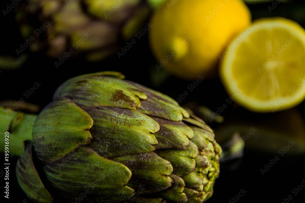 Fototapeta premium Artichokes posed and lemon on background