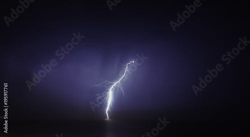 3d render of a black laptop isolated on white. The screen shows blue cyan flames and  abstract wave image. the screen is open and facing forward © dan