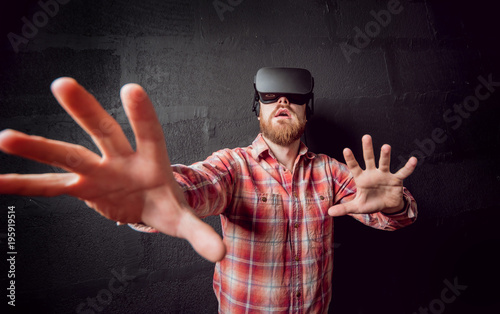 The young man wearing virtual reality goggles