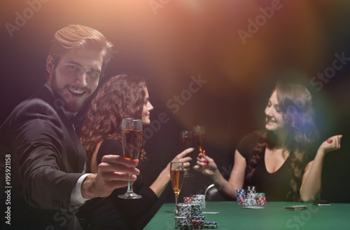 happy group of people celebrating a successful game of poker