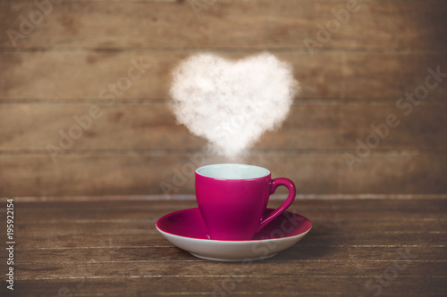 Cup of coffee with ehart shape steam photo