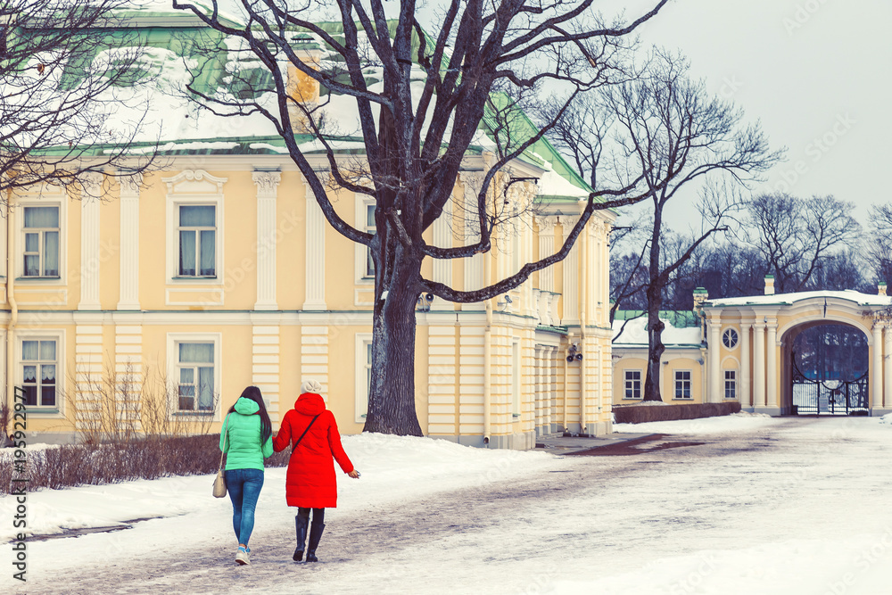 Mom and daughter in the park in the winter at sunset in Russia Mom and daughter in the park in the winter at sunset in Russia