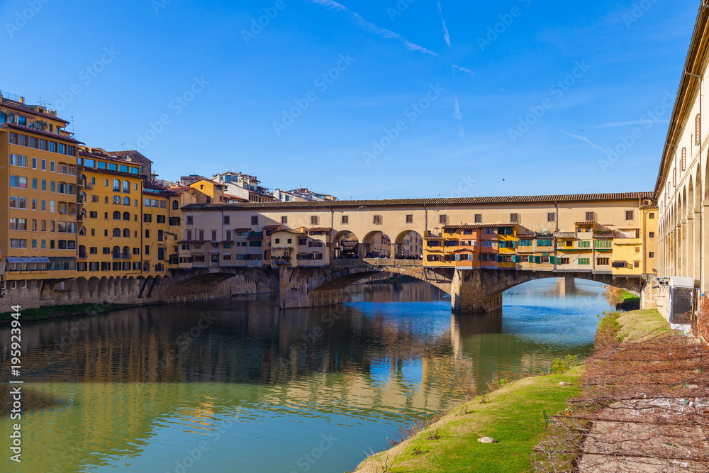 Arno river, houses and old Ponte Vecchio bridge, Florence, Tuscany, Italy