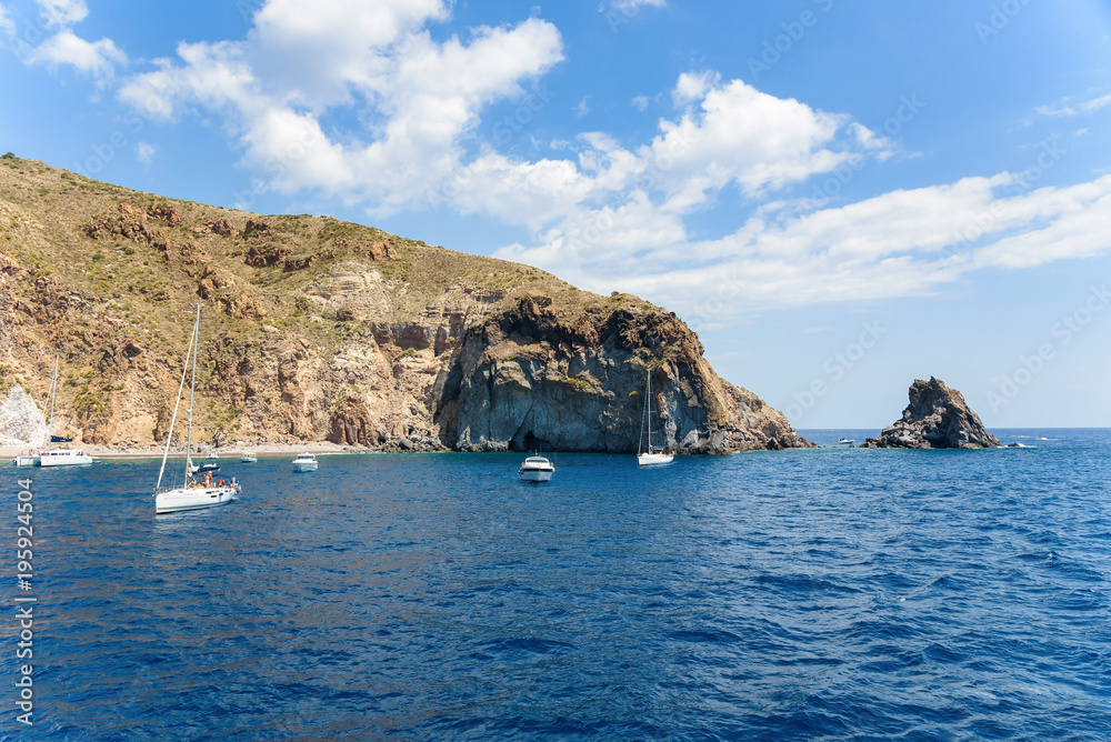 Yachts at the rocky coast of Lipari Island Yachts at the rocky coast of Lipari Island