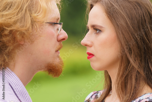 Serious man and woman looking in eyes