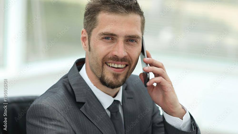 closeup.businessman working on laptop and talking on the phone closeup.businessman working on laptop and talking on the phone