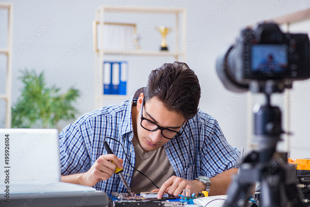 Vlogger recording computer repair on camera for vlog blog Vlogger recording computer repair on camera for vlog blog