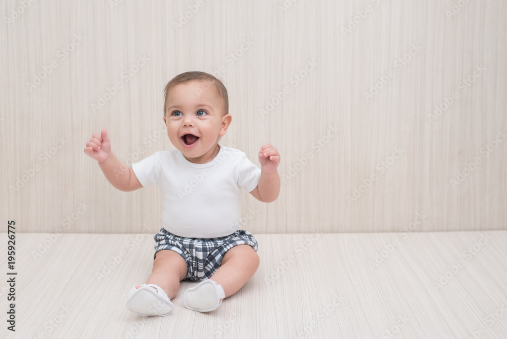 Blue-eyed baby boy on white wooden background Blue-eyed baby boy on white wooden background