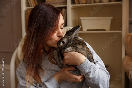 Happy woman kissing Easter bunny at Easter day