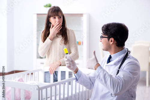 Doctor explaining to young mother 