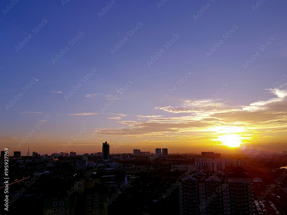 Fototapeta premium Beautiful sunset with silhouette of buildings over Johor Bahru's cityscape in Malaysia