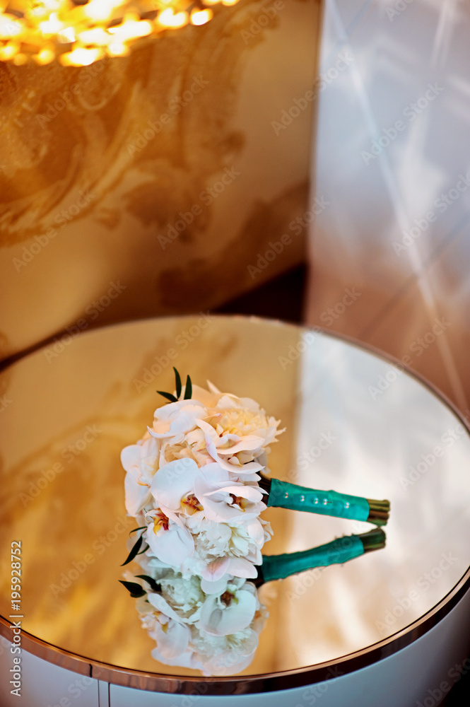 white Wedding bridal bouquet with emerald tape on the mirror with reflections before wedding ceremony with decoration a lot of flowers and colorful tape shot taken by selective soft focus and macro white Wedding bridal bouquet with emerald tape on the mirror with reflections before wedding ceremony with decoration a lot of flowers and colorful tape shot taken by selective soft focus and macro