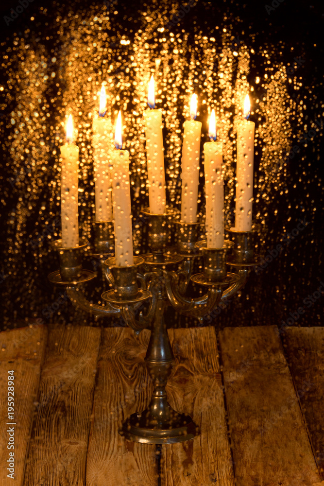 Water drops on the glass blurred on the background of a burning candle