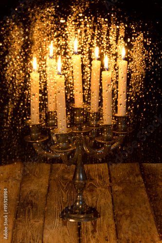 Water drops on the glass blurred on the background of a burning candle