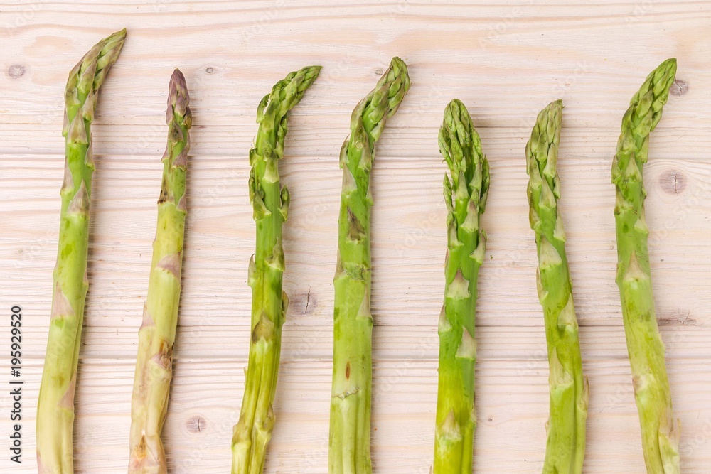 Fresh green asparagus shoots pattern, top view. Isolated over white. Food background asparagus flat lay pattern Fresh green asparagus shoots pattern, top view. Isolated over white. Food background asparagus flat lay pattern