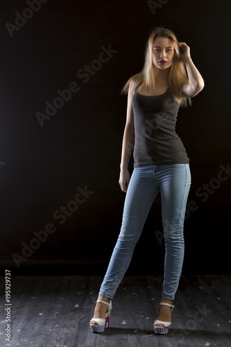 young woman with arms crossed isolated on black background photo