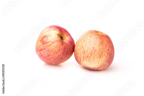Fuji apples with drops of water on white background