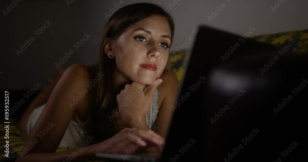 4k, An attractive woman addicted to online shopping browsing the internet late at night. Slow motion. 4k, An attractive woman addicted to online shopping browsing the internet late at night. Slow motion.