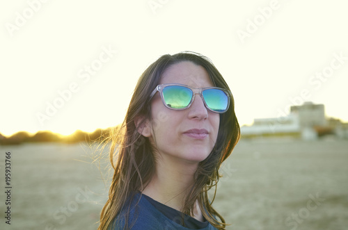 Portrait of young woman with sunglasses at sunset © sunlight19