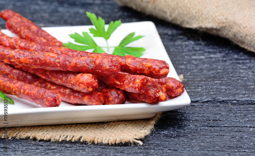 Dried sausages in a plate on table Dried sausages in a plate on table