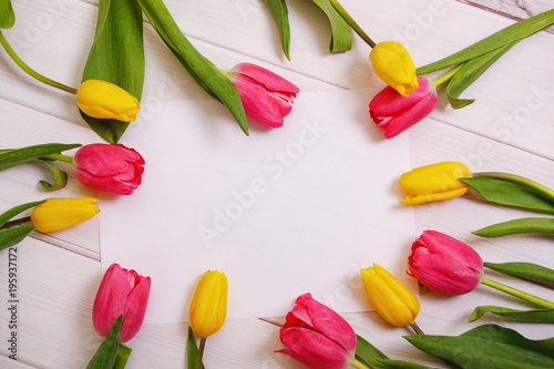 Red and yellow tulips flowers  on light wooden