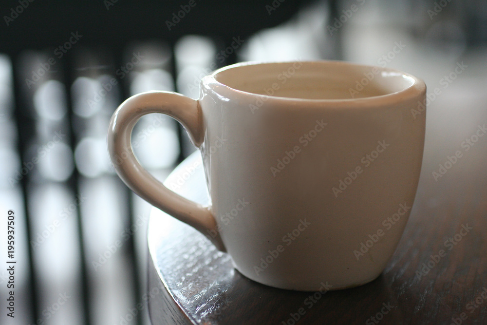 White coffee cup on black blurred and bokeh background. Coffee and drink concept White coffee cup on black blurred and bokeh background. Coffee and drink concept