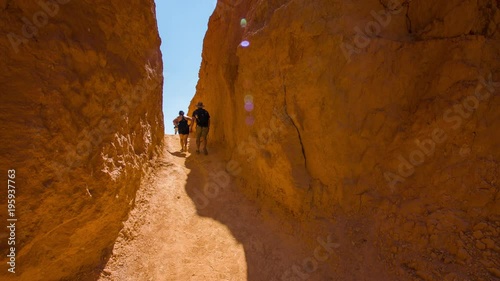 People walking along the narrow trail. Nature video. Amazing mountain landscape. Spectacular view at the cliffs. Bryce Canyon National Park. Utah. USA. 4K, 3840*2160, high bit rate, UHD