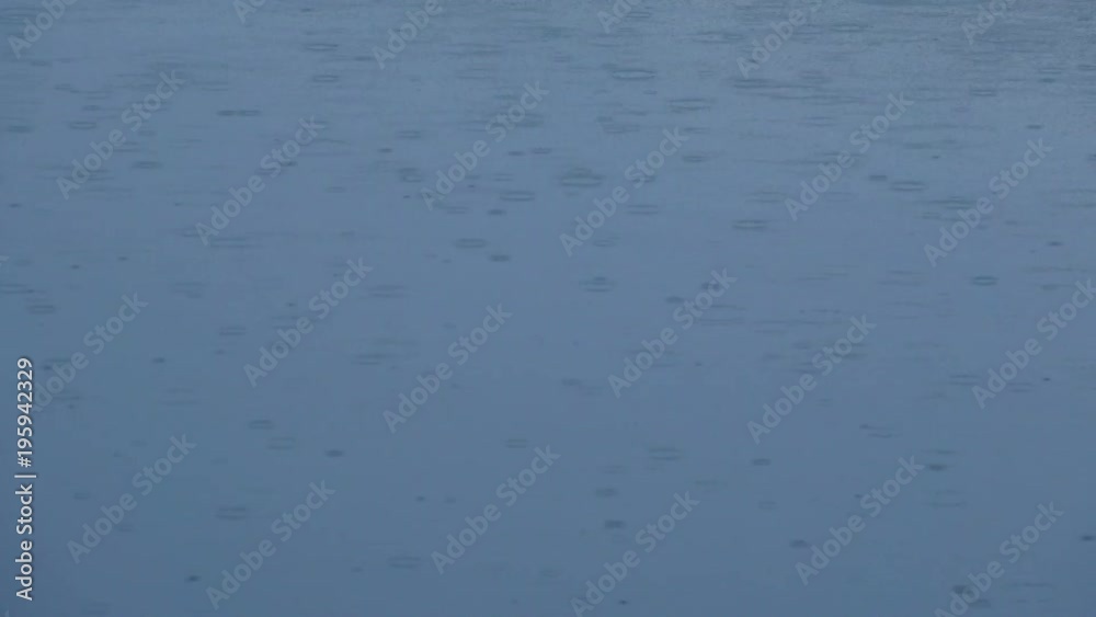 Rain water drop falling to the lake surface Rain water drop falling to the lake surface