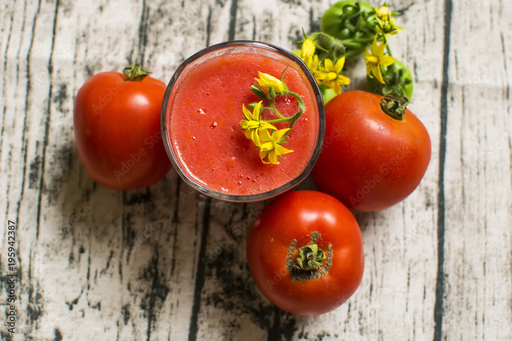 Tomato smoothie - tomato juice on wood background