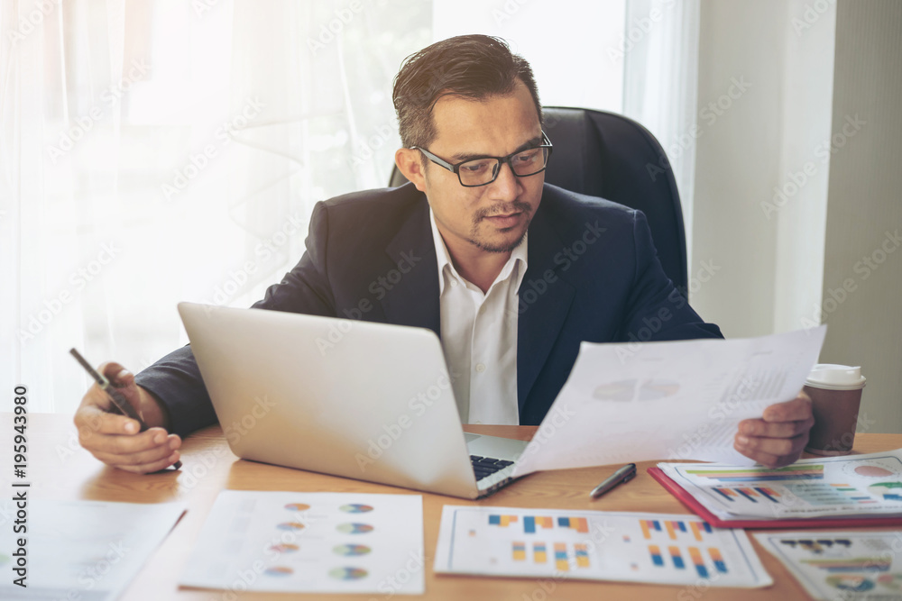 Business man busy standing at office desk on documents working , business concept Business man busy standing at office desk on documents working , business concept