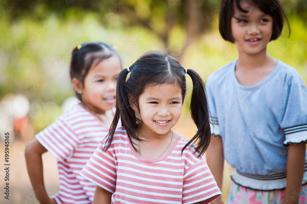 Happy asian child girl smiling and playing with her friend in the park Happy asian child girl smiling and playing with her friend in the park