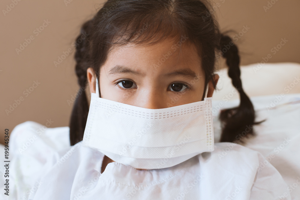 Sick asian little child girl wear protection mask while live in the hospital