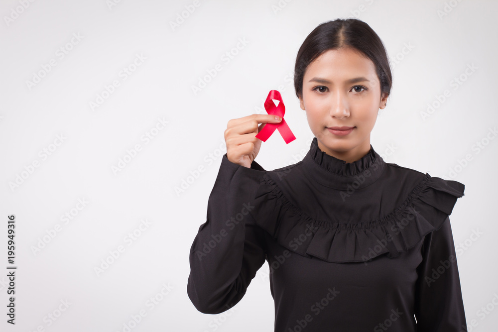 woman hand holding red ribbon bow, hiv or aids awareness symbol presented by woman in studio shot. medical, charity, fund raising concept for red ribbon hiv aids day awareness woman hand holding red ribbon bow, hiv or aids awareness symbol presented by woman in studio shot. medical, charity, fund raising concept for red ribbon hiv aids day awareness