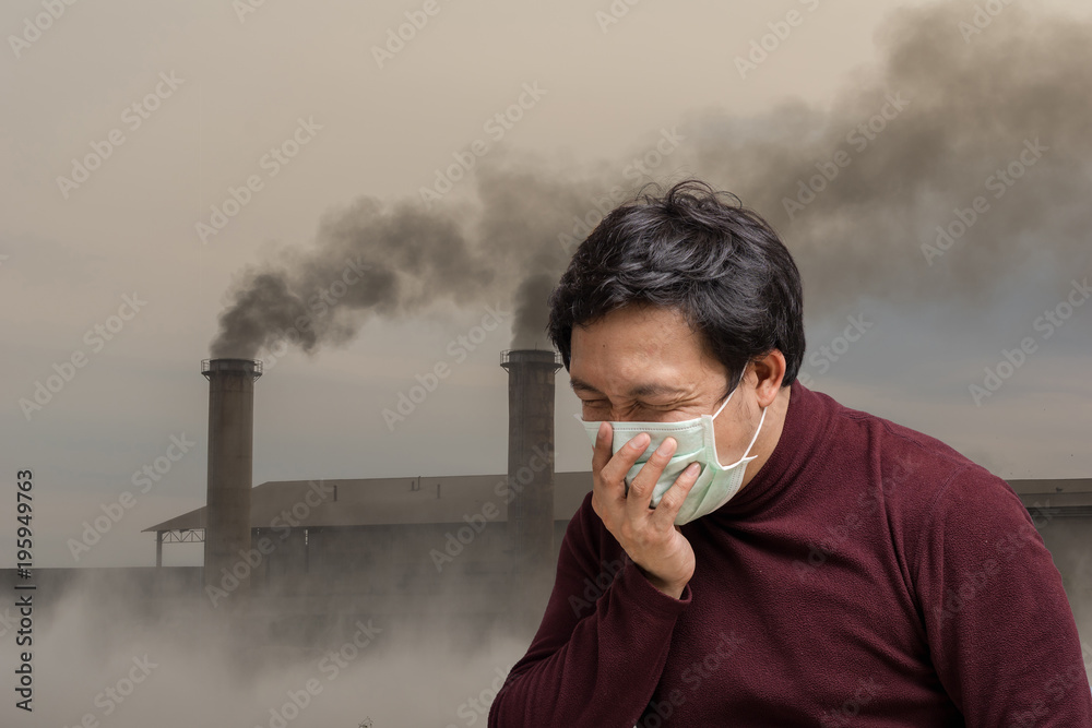 Plakat Asian man wearing the face mask against air pollution with coughing over the Smokestack Factory with black smoke on the sky with cloud, healthcare with industry and pollution concept