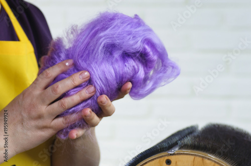 Felting wool. Combing the wool of alpaca or llama before felting on a special machine with a drum comb. photo