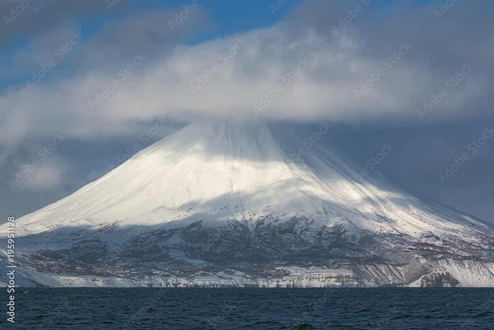 volcano on the Kuril Islands during snowfall