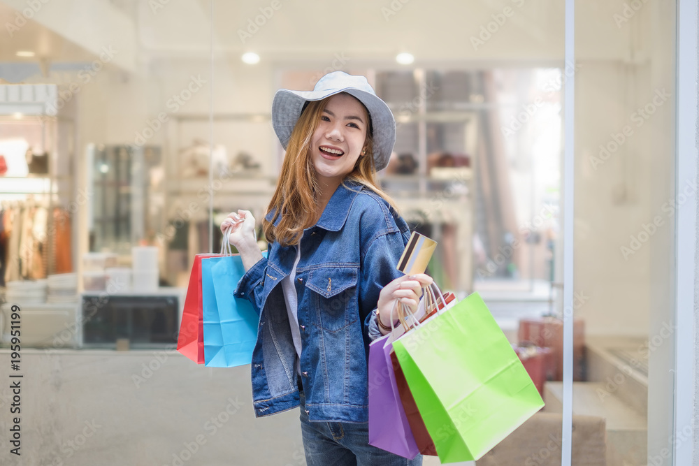 Happiness woman smiling and holding shopping bags, with copyspace for slogan or text message.