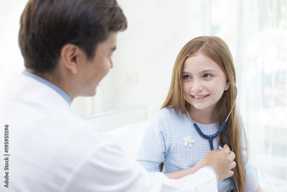 Doctor teaching girl how to use stethoscope with attractive smiling. Doctor teaching girl how to use stethoscope with attractive smiling.