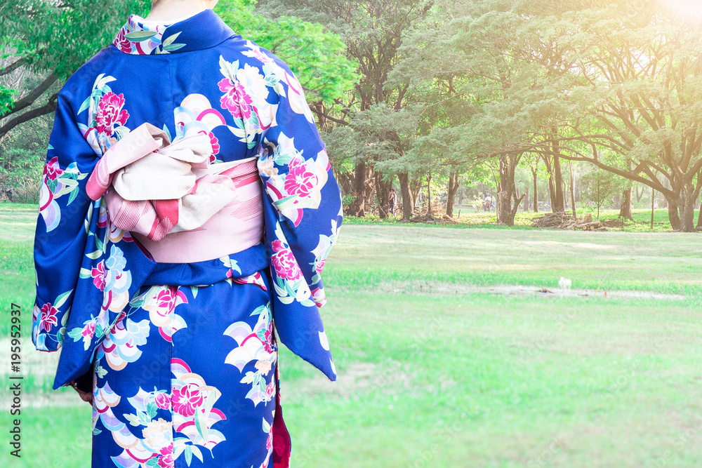 Woman wearing Kimono traditional Japan walking at public park.