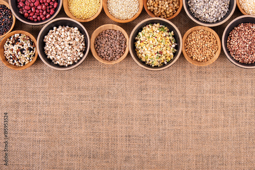 Variety of rice and grains in bowls on linen tablecloth